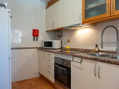 a living room with yellow curtains and a couch at Quinta do Paiva Apartment by Stay ici Algarve Holiday Rental in Albufeira