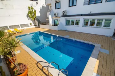 a swimming pool in front of a house at Downtown Studio - By D`alma Portuguesa in Albufeira