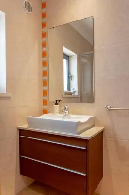 a bathroom with a sink and a mirror at Moradia Flaj in Olhos de Água