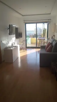 a living room with a couch and a tv and a table at Algarve Apartment, Faro - Excellent Location in Faro