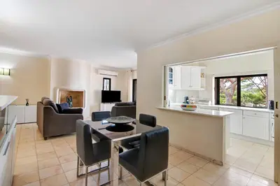 a kitchen and living room with a table and chairs at Apartamento Tennis View in Almancil