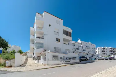 a white apartment building on the side of a street at Albufeira Old Town Sea View Apartment in Albufeira