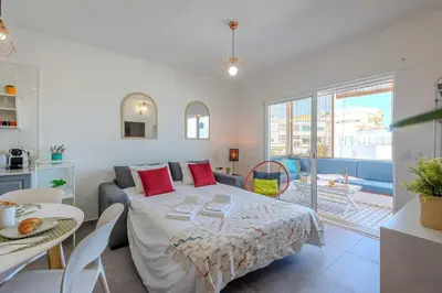 a bedroom with a bed and a living room at Albufeira Old Town Sea View Apartment in Albufeira