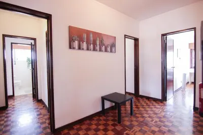 a room with two mirrors and a table on the wall at 4 Bedroom in Faro Downtown in Faro