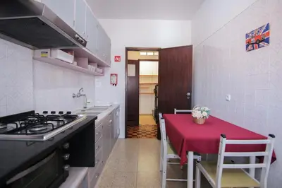 a kitchen with a table with a red table cloth at 4 Bedroom in Faro Downtown in Faro