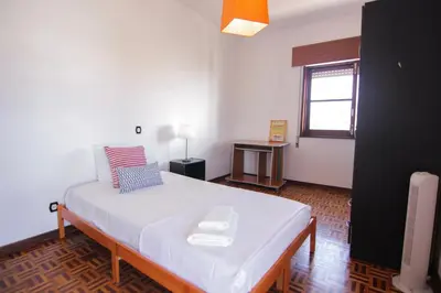 a bedroom with a large bed in a room at 4 Bedroom in Faro Downtown in Faro