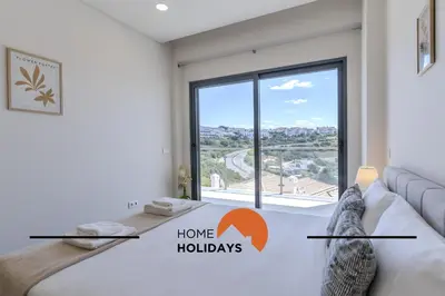 a bedroom with a couch and a large window at #312 Ocean Outlook by Home Holidays in Páteo