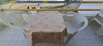 a table with a table cloth on top of a chair at Caranguejo Apartment in Albufeira