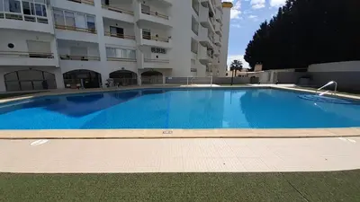 a large swimming pool in front of a building at Caranguejo Apartment in Albufeira