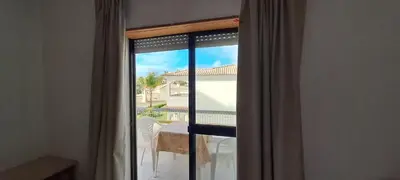 a room with a window with a view of a patio at Caranguejo Apartment in Albufeira
