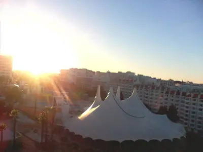 a large white tent in front of a city at Apartamento Ariadna in Albufeira