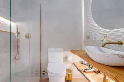 a bathroom with a white toilet and a sink at Sandora Dune by Seareen in Albufeira