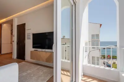 a white living room with a white table and chairs at Sandora Dune by Seareen in Albufeira
