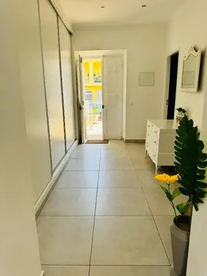 a hallway with a tile floor and a white dresser at Blife Montya private rooms in Faro