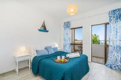 a bedroom with a bed with a tray of food on it at Seaside Charm Flat w/ Balcony by HostWise in Albufeira