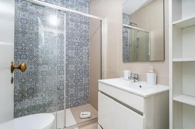 a bathroom with a toilet and a sink and a shower at Seaside Charm Flat w/ Balcony by HostWise in Albufeira