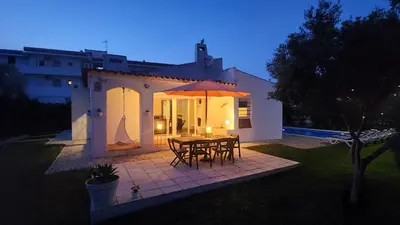 a patio with a table and chairs and an umbrella at Strip II by Check-in Portugal in Albufeira