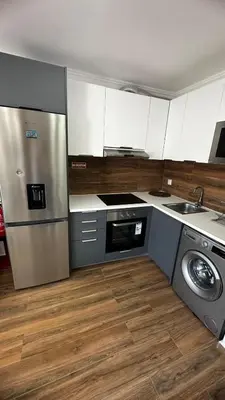 a kitchen with a stainless steel refrigerator and a dishwasher at Albufeira Oura Apartment II in Albufeira