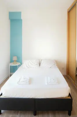 a bedroom with a bed with a white mattress at Dona Maria Guest House in Faro