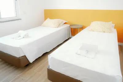 two beds sitting next to each other in a room at Dona Maria Guest House in Faro