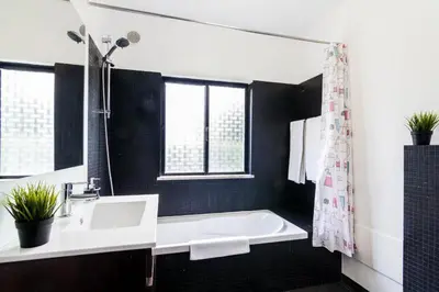a bathroom with a sink and a bath tub at Vivenda Duas Sentinelas 42 in Quarteira