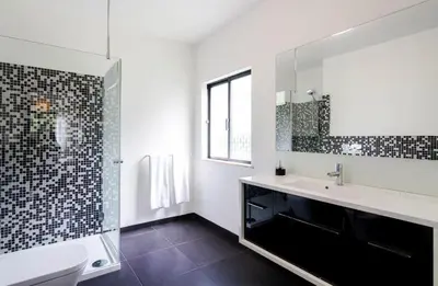 a bathroom with a sink and a toilet and a mirror at Vivenda Duas Sentinelas 42 in Quarteira