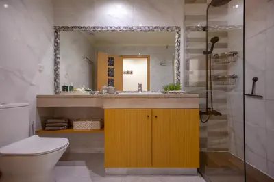 a bathroom with a sink and a toilet and a mirror at Casa do sol in Olhos de Água