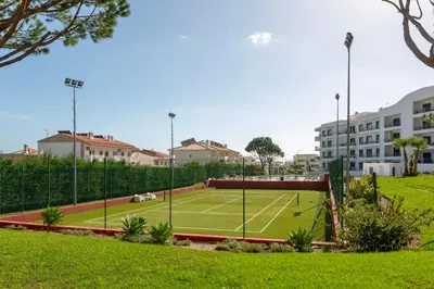 a tennis court in the middle of a park at Casa do sol in Olhos de Água