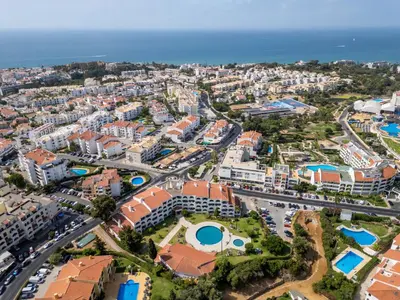 a large white building with cars parked in front of it at Apartment Sol Salgado by Interhome in Albufeira