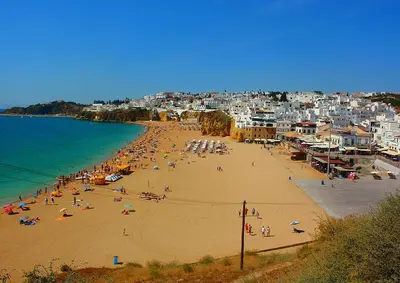a group of people on a beach with the ocean at Pescadores by Check-in Portugal in Albufeira