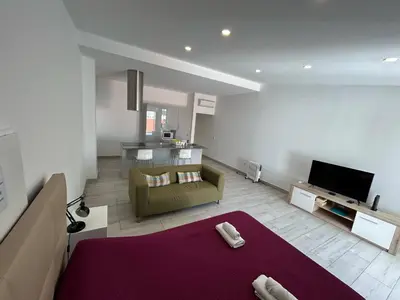a living room with a couch and a tv at Casa Madalena in Faro