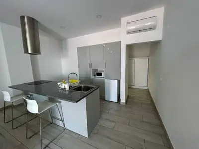 a kitchen with a sink and a counter top at Casa Madalena in Faro