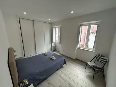 a bedroom with a bed and a chair in it at Casa Jonhy in Faro