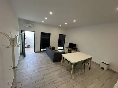 a living room with a table and a couch at Casa Jonhy in Faro