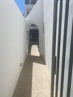 a hallway of a white building with an open door at Casa Jonhy in Faro