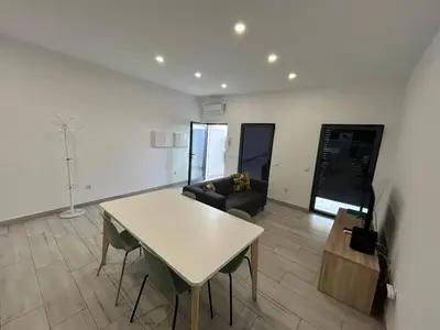 a living room with a table and a couch at Casa Jonhy in Faro
