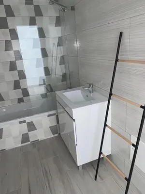 a bathroom with a white sink and a shower at Casa Foka in Faro