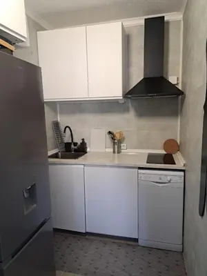 a small kitchen with white cabinets and a sink at SMILE Apartment Albufeira in Albufeira