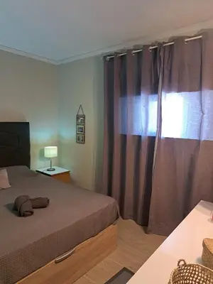 a bedroom with a bed and a window with curtains at SMILE Apartment Albufeira in Albufeira