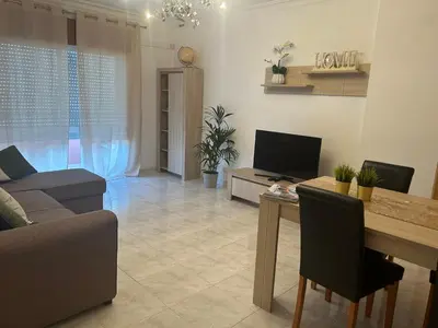 a living room with a couch and a dining room table at Penha House II in Faro
