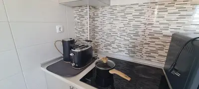 a kitchen with a counter with a coffee maker on it at Porto Marina Vilamoura LG Studio in Quarteira