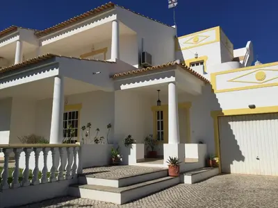 a white house with a gate and a fence at Villa Roja Pé by Dream Villas Algarve in Albufeira