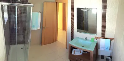 a bathroom with a glass shower and a sink at Villa Roja Pé by Dream Villas Algarve in Albufeira