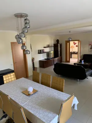 a dining room and living room with a table and chairs at Villa Roja Pé by Dream Villas Algarve in Albufeira