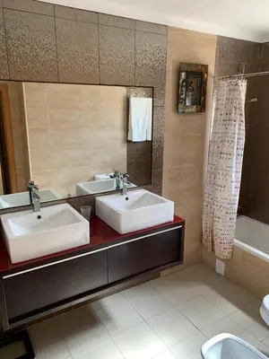 a bathroom with two sinks and a mirror and a tub at Villa Roja Pé by Dream Villas Algarve in Albufeira