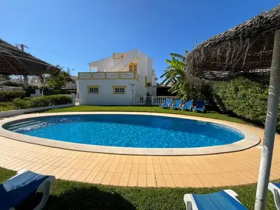 a swimming pool in front of a house at Villa Roja Pé by Dream Villas Algarve in Albufeira