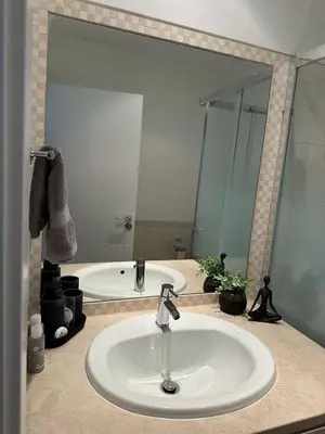a bathroom with a sink and a tub and a mirror at Luz do Mar in Olhos de Água