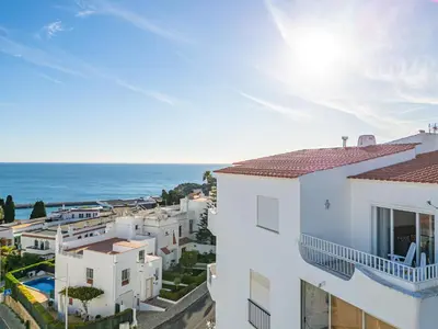 an image of a building with the ocean in the background at Apartment Atlas in Albufeira