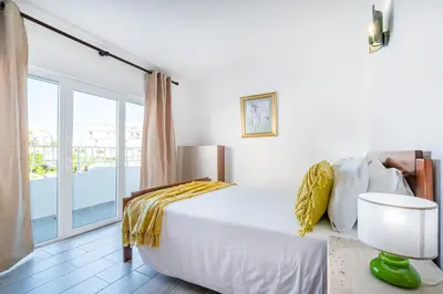 a bedroom with a bed and a balcony at Apartment Atlas in Albufeira