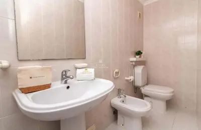a bathroom with a sink and a toilet and a mirror at Downtown Apartment - By D`alma Portuguesa in Albufeira